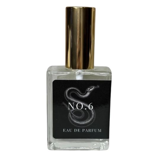 Perfume bottle labeled 'No. 6 Eau de Parfum' with a gold cap on a white background