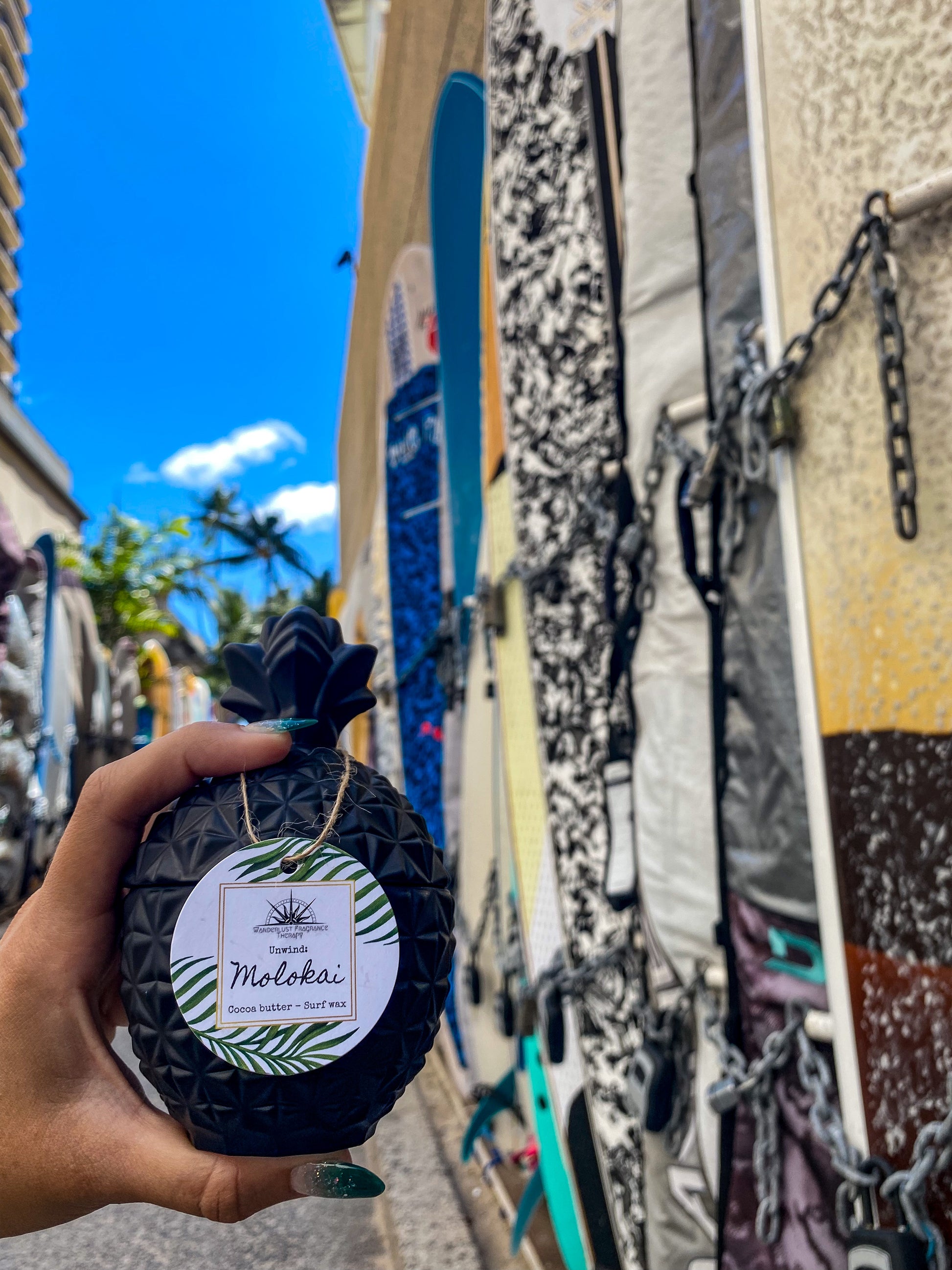 Candle in black pineapple jar scented with cocoa butter and surf wax.